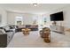 Spacious living room featuring large windows, carpet flooring, and a plush gray sectional sofa at 433 Sinaloa St, Waxhaw, NC 28173