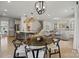 Bright and open living area featuring a dining space, kitchen, hardwood floors, and modern lighting at 433 Sinaloa St, Waxhaw, NC 28173