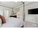 Spacious main bedroom with a four-poster bed, TV, and ensuite bathroom access, designed for comfort and style at 433 Sinaloa St, Waxhaw, NC 28173