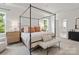 Beautiful main bedroom with a four-poster bed, large window, and ensuite bathroom featuring contemporary finishes at 433 Sinaloa St, Waxhaw, NC 28173