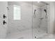 Stylish bathroom shower featuring elegant marble-look tile, rain showerhead, and a built-in bench for relaxation at 433 Sinaloa St, Waxhaw, NC 28173