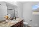 Well-lit bathroom with granite countertops, modern fixtures, and a glass-enclosed shower at 4500 Carrington Dr, Lancaster, SC 29720