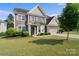 Charming two-story home featuring stone accents, a well-manicured lawn, and a two-car garage at 4500 Carrington Dr, Lancaster, SC 29720