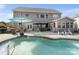 Spacious backyard with pool, outdoor dining area, lush landscaping, and seating at 4500 Carrington Dr, Lancaster, SC 29720