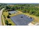 Aerial view showing a tennis court and parking lot amidst the community's amenities and green spaces at 4500 Carrington Dr, Lancaster, SC 29720