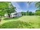 Large backyard with green grass and a wooded treeline at 4712 Avalon Forest Ln, Charlotte, NC 28269