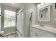 Clean bathroom with a shower, vanity, and natural light from the window at 4712 Avalon Forest Ln, Charlotte, NC 28269