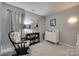 Charming Bedroom with a crib, rocking chair, and soft gray walls, creating a serene space at 4712 Avalon Forest Ln, Charlotte, NC 28269