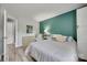 Inviting bedroom with a comfortable bed, soft lighting, and a calming teal accent wall at 4712 Avalon Forest Ln, Charlotte, NC 28269