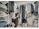 Walk-in closet filled with hanging clothes, shelves, and storage bins at 4712 Avalon Forest Ln, Charlotte, NC 28269