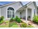 Inviting front porch with decorative wreath, bench, and lush landscaping at 4712 Avalon Forest Ln, Charlotte, NC 28269