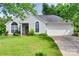 Charming single-story home with well-manicured lawn and attached garage on a sunny day at 4712 Avalon Forest Ln, Charlotte, NC 28269