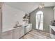 Bright kitchen featuring light gray cabinets, white subway tile backsplash, and floating wood shelves at 4712 Avalon Forest Ln, Charlotte, NC 28269