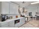 Modern kitchen with stainless steel appliances, sleek gray cabinets, and an adjacent dining area at 4712 Avalon Forest Ln, Charlotte, NC 28269