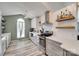 A modern kitchen with stainless steel appliances, light grey cabinets and countertops, and a large window at 4712 Avalon Forest Ln, Charlotte, NC 28269
