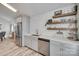 Kitchen area showcasing stainless steel appliances, light gray cabinets, wood-style flooring, and open shelving at 4712 Avalon Forest Ln, Charlotte, NC 28269