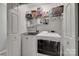 Functional laundry room with modern appliances, shelving, and ample storage space at 4712 Avalon Forest Ln, Charlotte, NC 28269