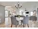 Open concept living room with hardwood floors, fireplace, and chandelier above the dining table at 4712 Avalon Forest Ln, Charlotte, NC 28269