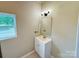 Bathroom with a single sink vanity, mirror, and decorative lighting at 502 E Main St, Cleveland, NC 27013