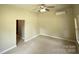 Comfortable bedroom featuring ceiling fan, mini-split system and neutral paint at 502 E Main St, Cleveland, NC 27013