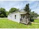 Exterior side view of cozy home featuring a covered front porch and green lawn at 502 E Main St, Cleveland, NC 27013
