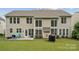 Spacious backyard with a well-maintained lawn, patio and exterior of home at 5046 Cressingham Dr, Fort Mill, SC 29707