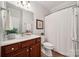 Bathroom featuring a dark wood vanity with a white countertop, a framed mirror and a white shower curtain at 5046 Cressingham Dr, Fort Mill, SC 29707