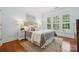 Serene bedroom with plantation shutters, hardwood floors, and a comfortable rug creating a peaceful retreat at 5046 Cressingham Dr, Fort Mill, SC 29707
