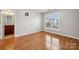 Well-lit bedroom with hardwood floors and large windows with neighborhood views at 5046 Cressingham Dr, Fort Mill, SC 29707