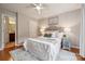 Cozy bedroom featuring a queen-size bed, stylish nightstands, ceiling fan, and hardwood floors at 5046 Cressingham Dr, Fort Mill, SC 29707