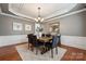 Cozy dining room with paneled walls, chandelier, and a large mirror at 5046 Cressingham Dr, Fort Mill, SC 29707