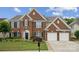 Beautiful two-story brick home featuring a manicured lawn and a two-car garage at 5046 Cressingham Dr, Fort Mill, SC 29707