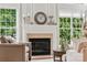 Close-up of the fireplace featuring mantle, hearth, decor and large windows at 5046 Cressingham Dr, Fort Mill, SC 29707