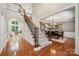 Elegant foyer with hardwood floors, staircase, and an adjacent dining room and living room at 5046 Cressingham Dr, Fort Mill, SC 29707