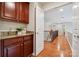 Hallway featuring a wet bar area, leading to a view of the staircase and upstairs hallway, providing convenience and style at 5046 Cressingham Dr, Fort Mill, SC 29707