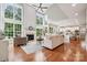 Spacious living room with high ceilings, a fireplace, large windows, and hardwood floors at 5046 Cressingham Dr, Fort Mill, SC 29707