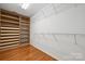 Large walk-in closet with custom wood shelving and hanging space for optimal storage at 5046 Cressingham Dr, Fort Mill, SC 29707