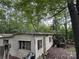 Exterior view of a home's weathered siding and a small porch surrounded by trees at 509 Waring Ct # Lot 4, Fort Mill, SC 29707