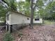A side view of the home with tan siding and dark green trees surrounding the property at 509 Waring Ct # Lot 4, Fort Mill, SC 29707