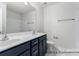Modern bathroom featuring double sinks, a dark vanity, and sleek fixtures, offering a luxurious feel at 5142 Tommy Ln # 1202, Stanley, NC 28164