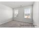 Cozy bedroom featuring neutral carpeting and two bright windows, creating a comfortable, light-filled space at 5142 Tommy Ln # 1202, Stanley, NC 28164