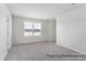 Bright bedroom with neutral carpet, a large window, and fresh, neutral paint for a relaxing atmosphere at 5142 Tommy Ln # 1202, Stanley, NC 28164