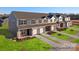 New townhomes featuring a mix of siding and brick, attached garages, and nicely manicured lawns at 5142 Tommy Ln # 1202, Stanley, NC 28164