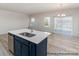 Kitchen island features a stainless steel sink with bright countertops and stainless steel appliances, open to the living area at 5142 Tommy Ln # 1202, Stanley, NC 28164