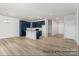 Spacious living room with modern blue cabinets, sleek hardwood floors, and abundant natural light at 5142 Tommy Ln # 1202, Stanley, NC 28164