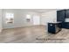 Living area featuring hardwood floors, large windows, and open kitchen with stainless steel sink and modern finishes at 5142 Tommy Ln # 1202, Stanley, NC 28164