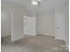 Carpeted bedroom with vaulted ceilings and two entryways at 5237 Ficus Tree Ln, Charlotte, NC 28215