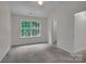 Cozy bedroom with neutral carpet, ceiling fan, and a window providing ample natural light at 5237 Ficus Tree Ln, Charlotte, NC 28215