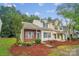 Charming townhouse with manicured front yard and colorful landscaping at 5237 Ficus Tree Ln, Charlotte, NC 28215
