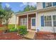 Charming front entrance with brick accents, a covered porch, and manicured landscaping at 5237 Ficus Tree Ln, Charlotte, NC 28215